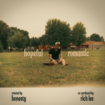 hopeful romantic front cover — honesty sitting in the grass with a guitar